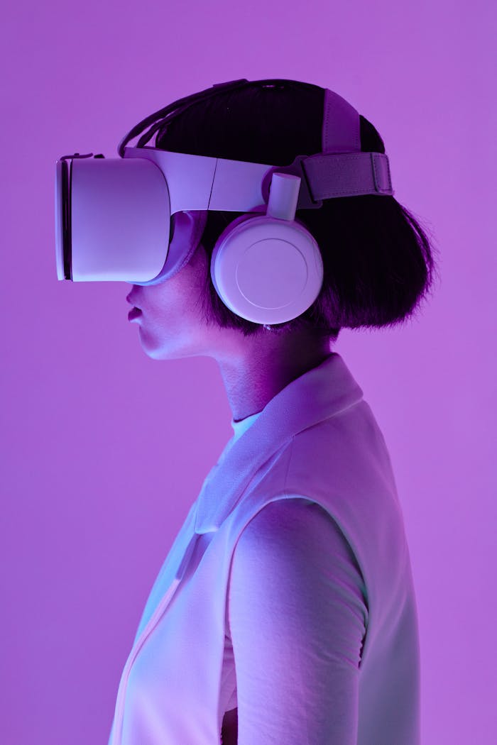 about-01 Side profile of a woman wearing VR goggles in a studio with purple lighting, embodying future tech.