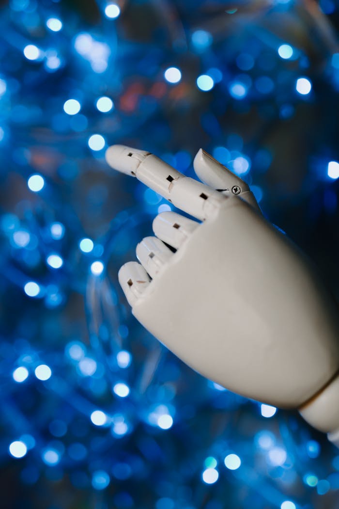 our-services-3 Close-up of a robotic hand with glowing blue bokeh background, symbolizing advanced technology.